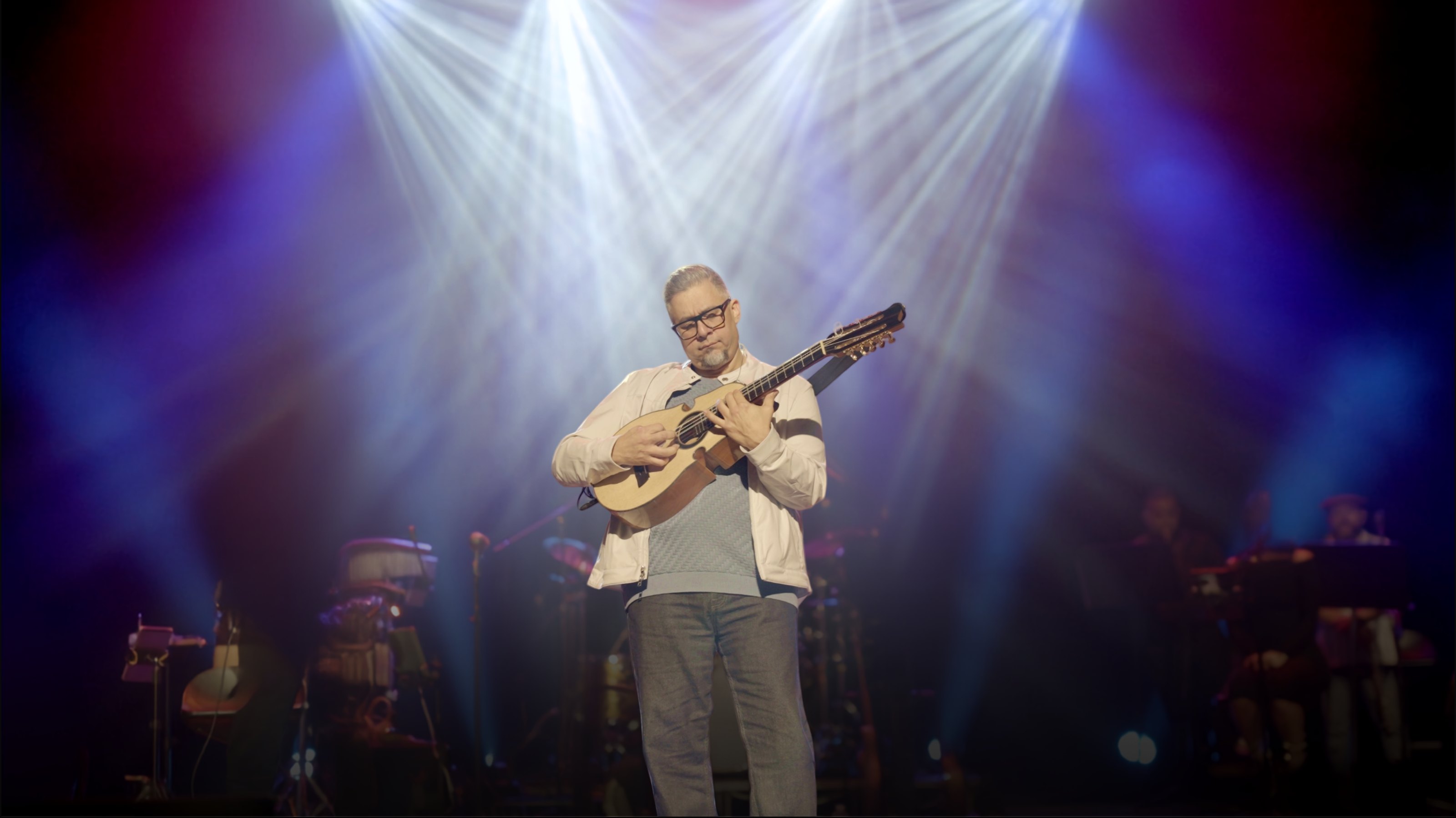 Quique Domenech on stage with his Puerto Rican cuatro